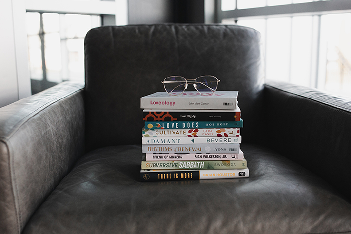 stack of books on an armchair