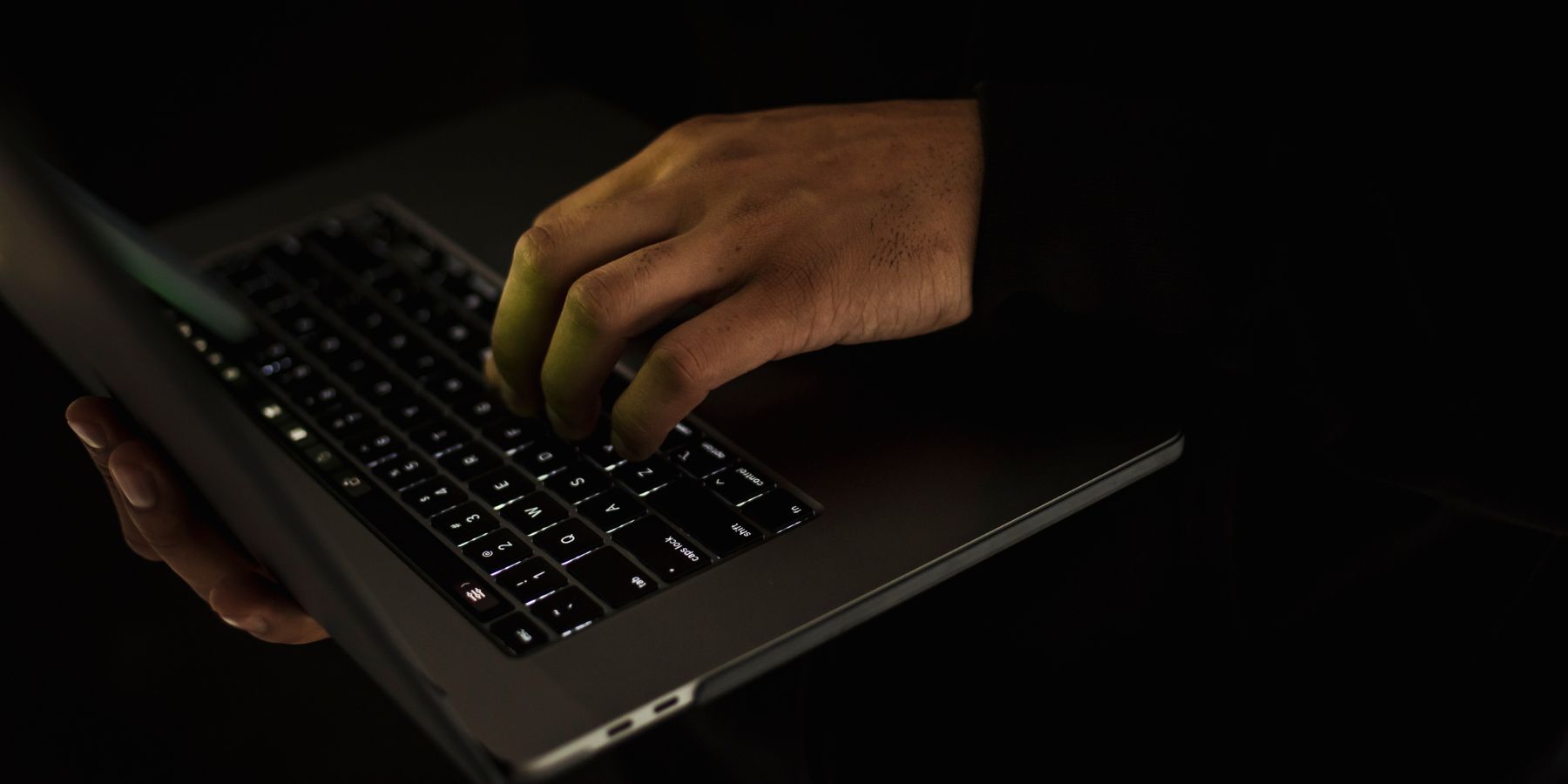 hands on a dark computer