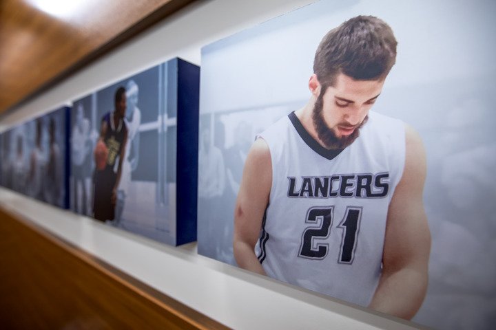 Large pictures of CBU Lancer athletes hanging on the wall in a hallway