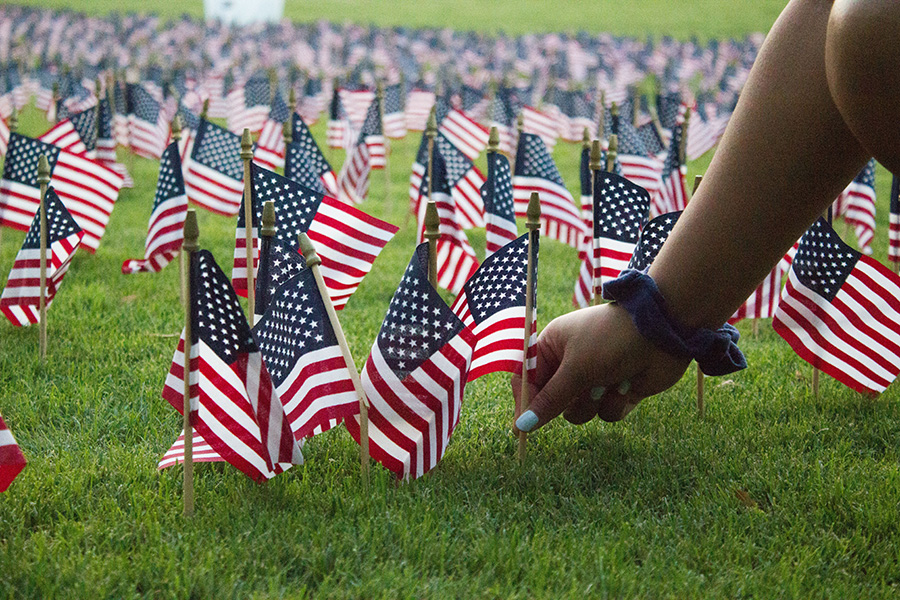 Student planting small American Flag