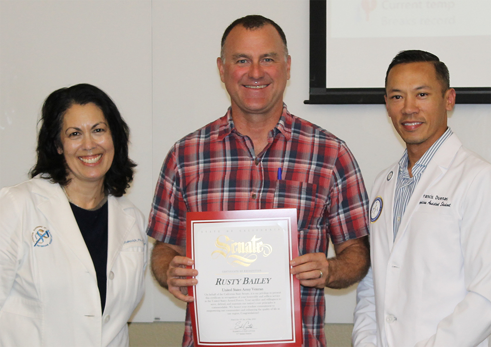 Dr. Mary Ann Nogaki Stahovich, former Mayor Rusty Bailey and student Francis Duenas