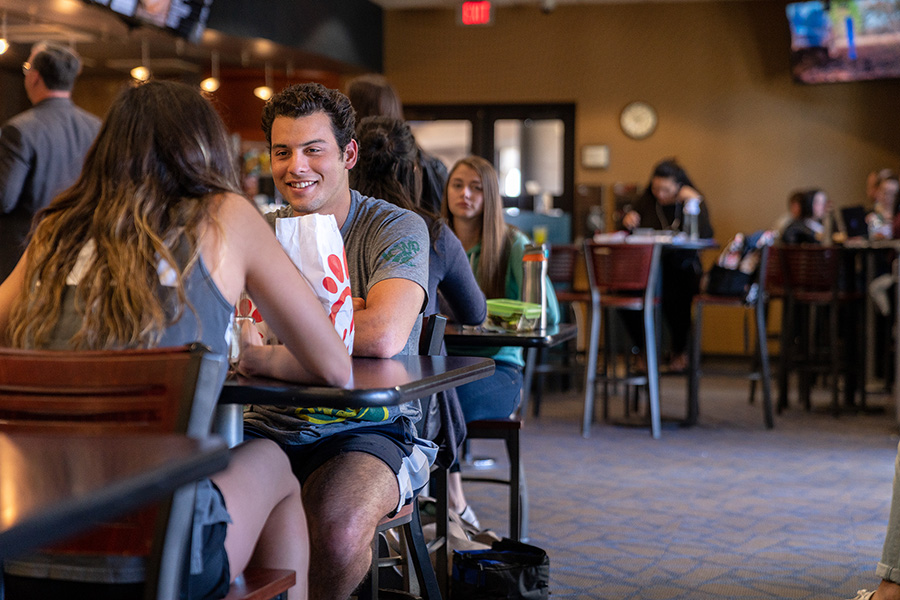girls walking on campus carrying chick-fil-a