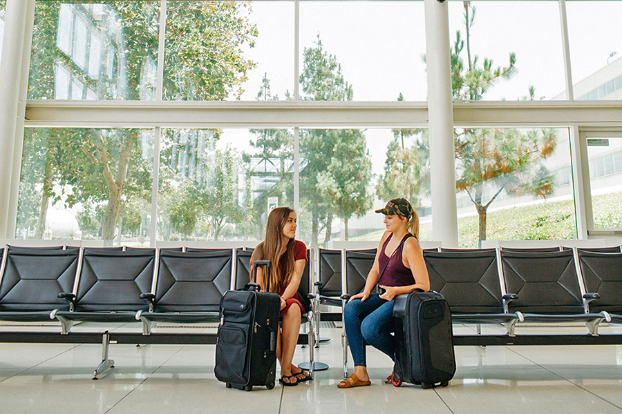two girls sitting in airport