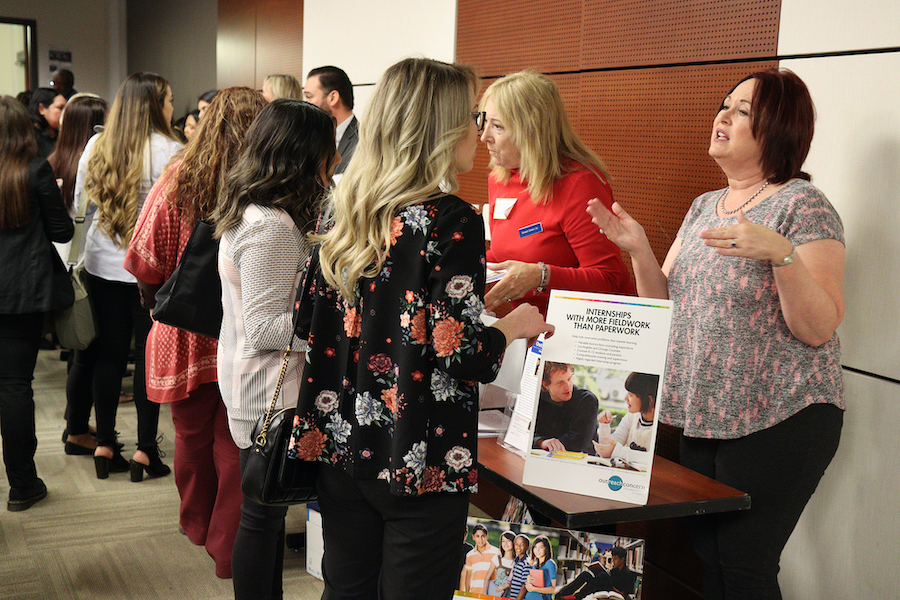 students conversing with representatives 