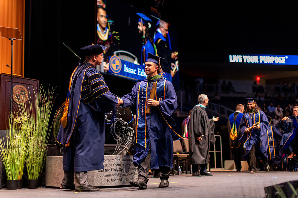 graduate walking across stage