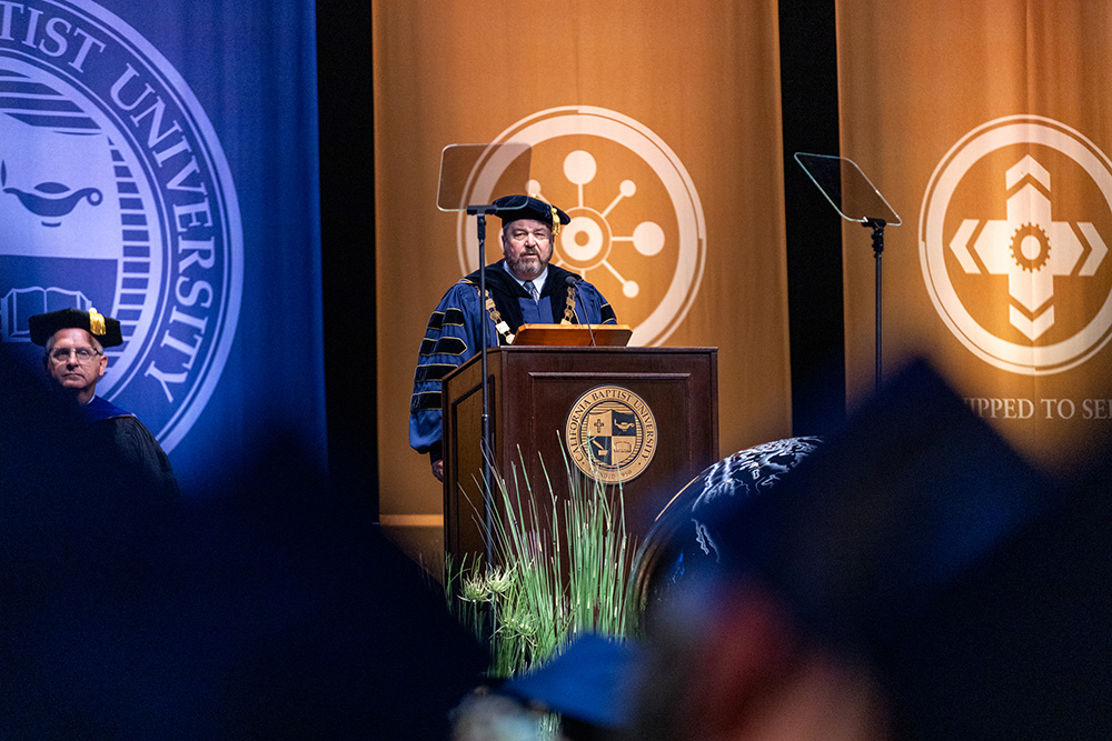 man speaking at podium