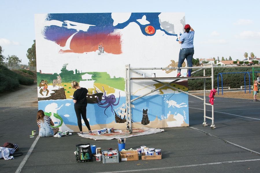 With the noise of elementary school-age kids playing in the background and with an occasional ball or two bouncing near them, California Baptist University art students continued with their task at hand—painting a mural in the school’s playground.