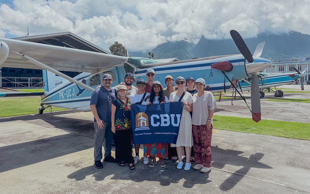 group standing by plane