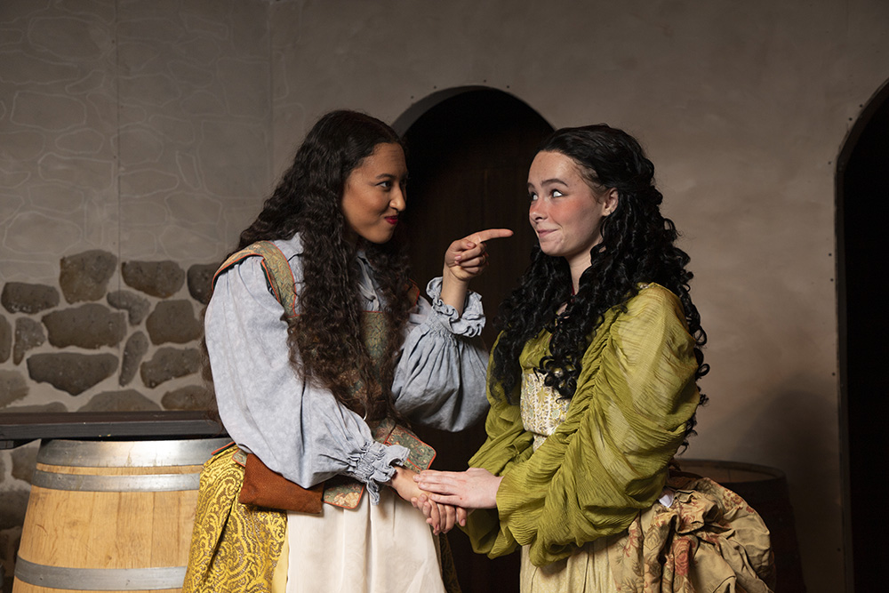 Two women pointing at each other