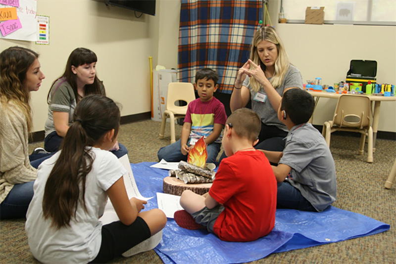 Graduate students from California Baptist University and a group                       of children gathered around a makeshift campfire to chat about tasty treats.