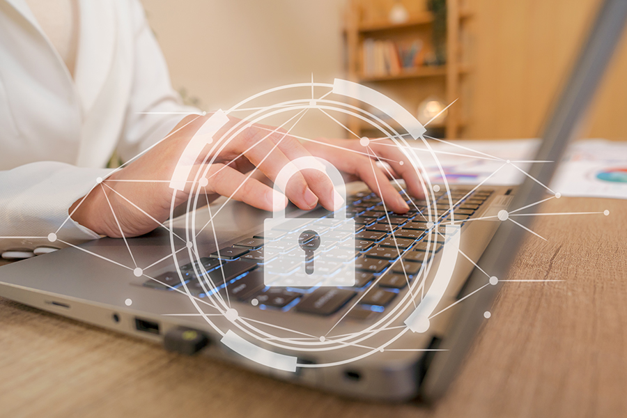 Hands typing on laptop with lock symbol