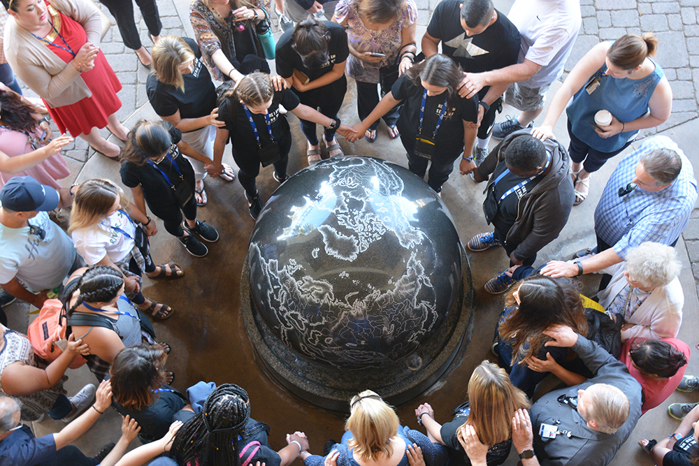 students praying around the kugel at cbu