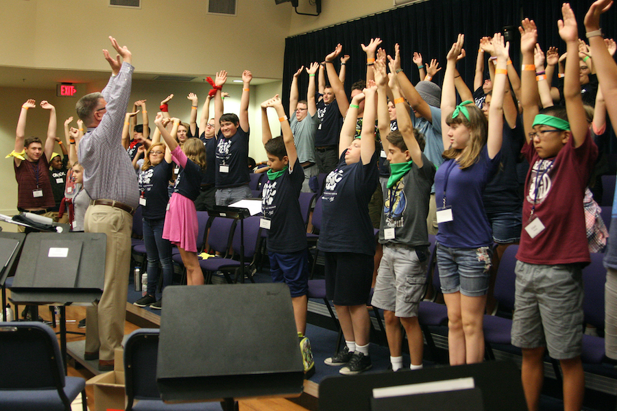 Young aspiring musicians reached for the sky in unison as Dr. Guy Holliday had them stretch and practice breathing exercises.