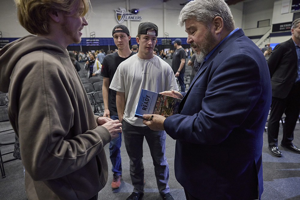 man signing autographs