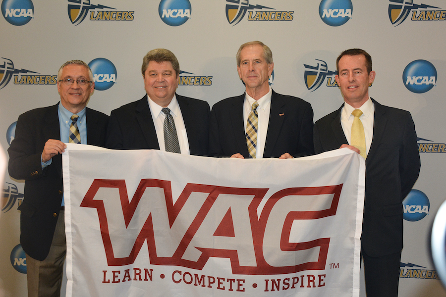 (From left) Kent Dacus, Dr. Ronald L. Ellis, Jeff Hurd (commissioner of Western Athletic Conference) and Dr. Micah Parker display the WAC conference banner at a press conference announcing California Baptist University’s transition into a NCAA Division I conference on Jan. 13. 