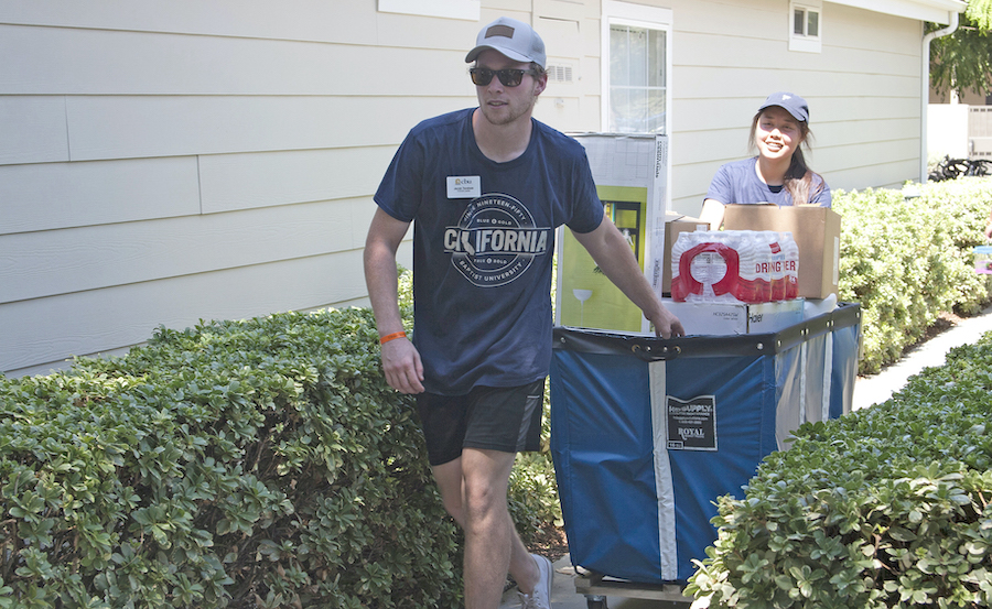 Jacob Tarabetz, a student FOCUS leader, helps transport a student’s belongings during Welcome Weekend at California Baptist University on Sept. 1.  