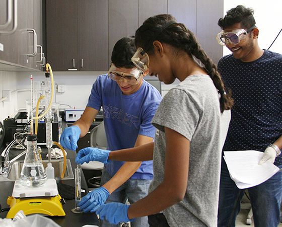 From left: Nathan Castro, of Ayala High School, Rana Eltahir, of Claremont High School, and Royce D’souza, of Deira International School, perform a distillation experiment during an introductory engineering course held at CBU for high school students.