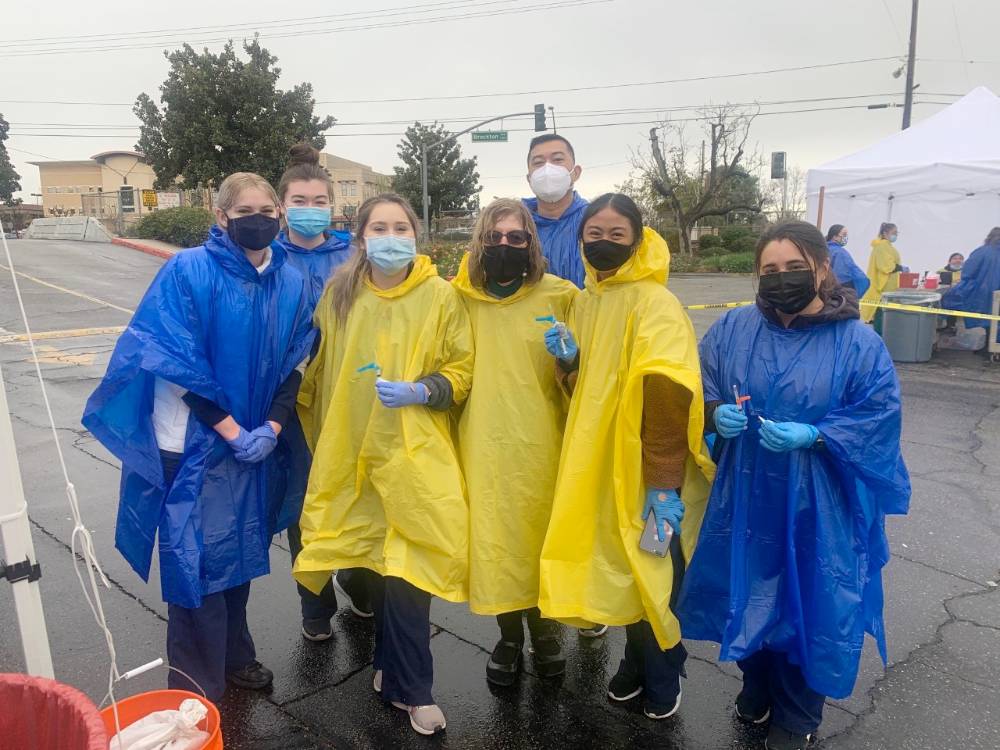 Nursing students from California Baptist University are assisting                       at COVID-19 vaccination clinics, helping to administer the injections.