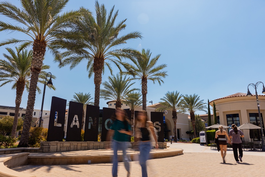 Lancer Plaza with students walking around with the letters L A N C E R S in the background
