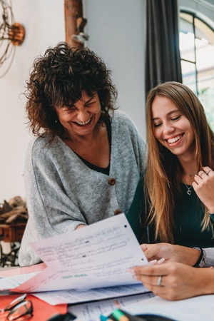 A student and parent reading and reviewing a paper