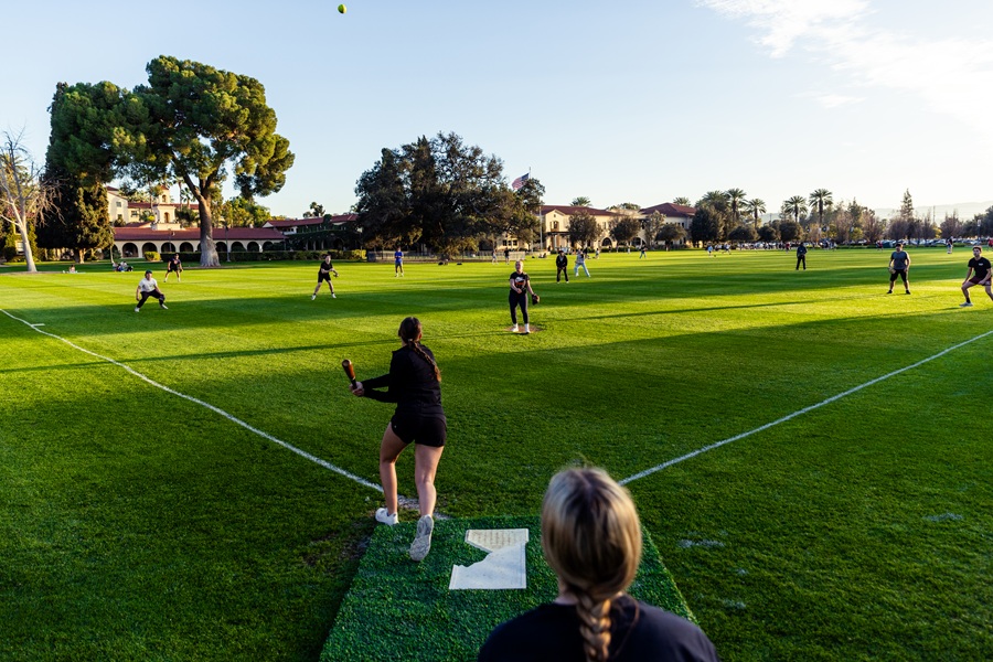 Softball team player at bat on the field