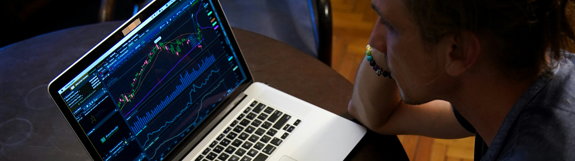 Man on laptop with graphs