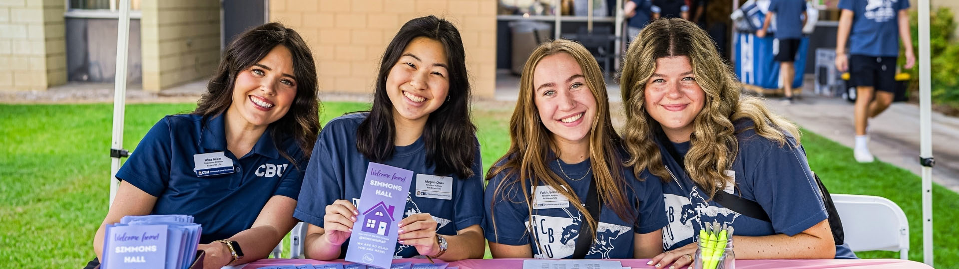 4 students posing at a table