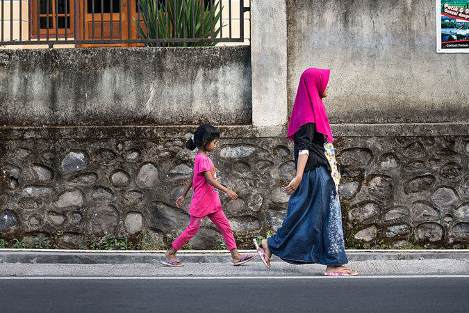 woman and child walking on street
