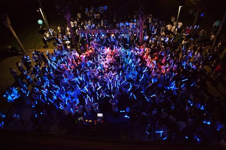 CBU students holding glow sticks at a night time event
