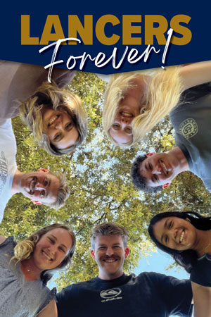 7 students looking down in a circle with the logo "Lancers Forever" at the top