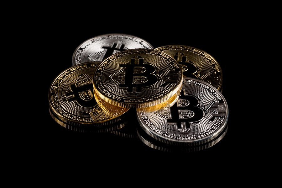 5 bitcoins on a dark backdrop