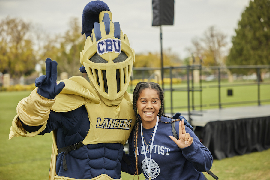student with lance mascot