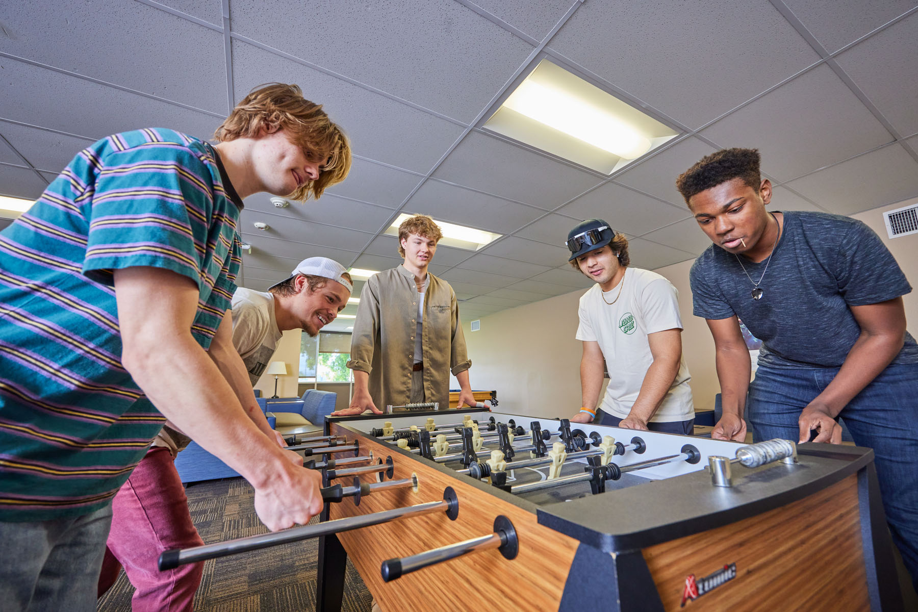 Five CBU students playing foosball on campus